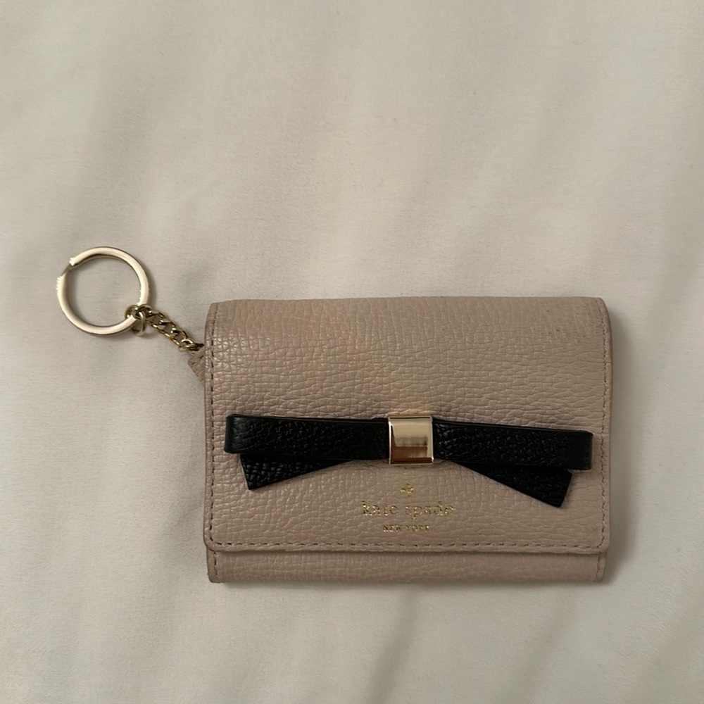 Kate Spade tan Wallet with license compartment and zippered coin pocket.